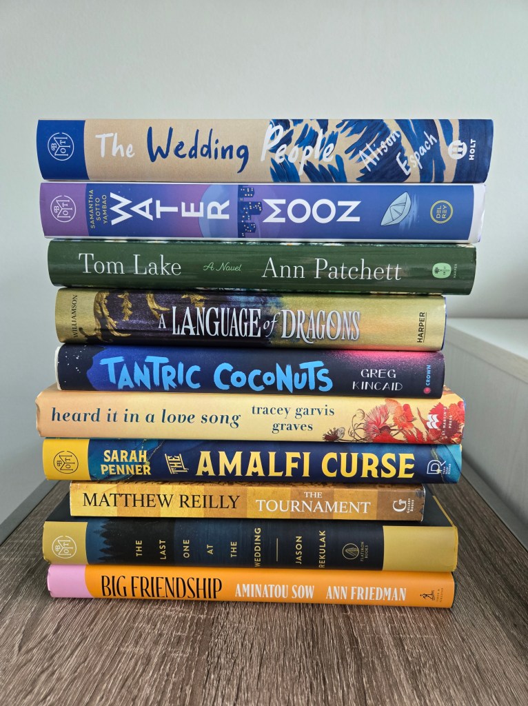 Stack of books for summer TBR reading challenge with 10 themed prompts